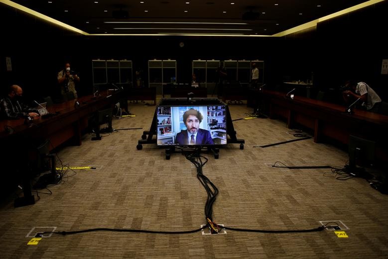 Canada's Prime Minister Justin Trudeau is seen on a screen as he attends a House of Commons finance committee meeting in Ottawa, Ontario, Canada July 30. REUTERS/Blair Gable